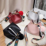 Small Bucket Crossbody Bag with Fur Ball and Wide Strap