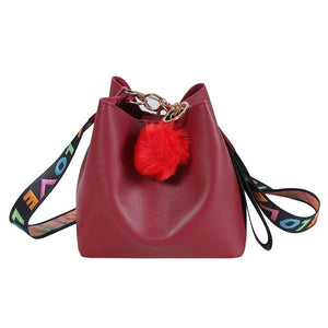 Small Bucket Crossbody Bag with Fur Ball and Wide Strap