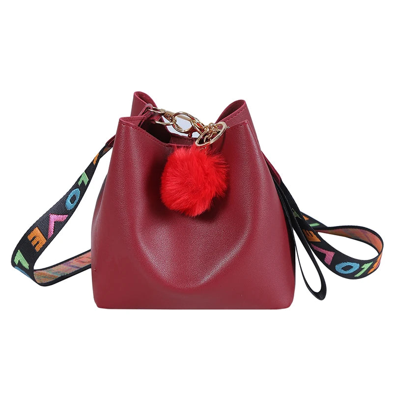 Small Bucket Crossbody Bag with Fur Ball and Wide Strap